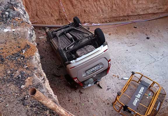 Kerala registration car falls into pit for underpass works at Ambalpady